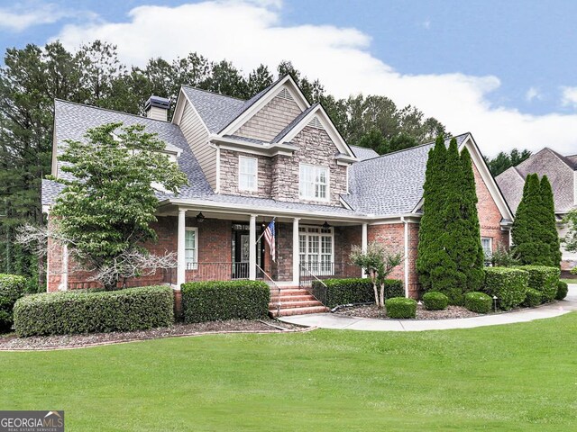 414 Candler Trl, Canton, GA 30115 - craftsman inspired home with a porch, a front yard, roof with shingles, and brick siding