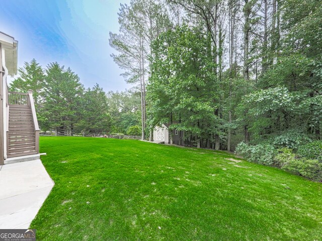 414 Candler Trl, Canton, GA 30115 - view of yard featuring stairway and a storage unit