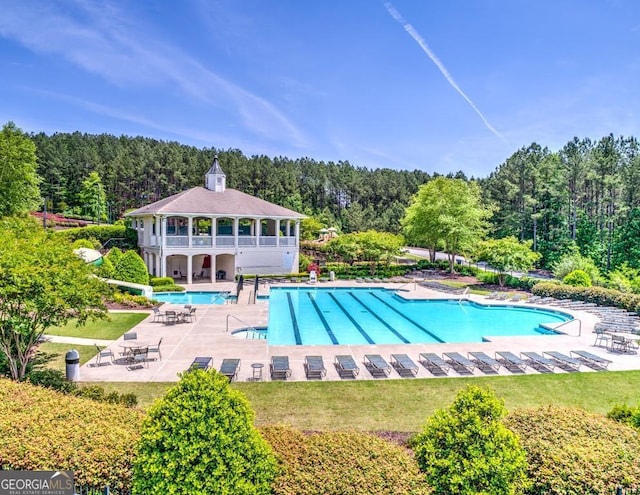 414 Candler Trl, Canton, GA 30115 - community pool featuring a wooded view, a patio, and a lawn