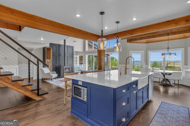 kitchen featuring blue cabinetry, a sink, appliances with stainless steel finishes, light countertops, and recessed lighting