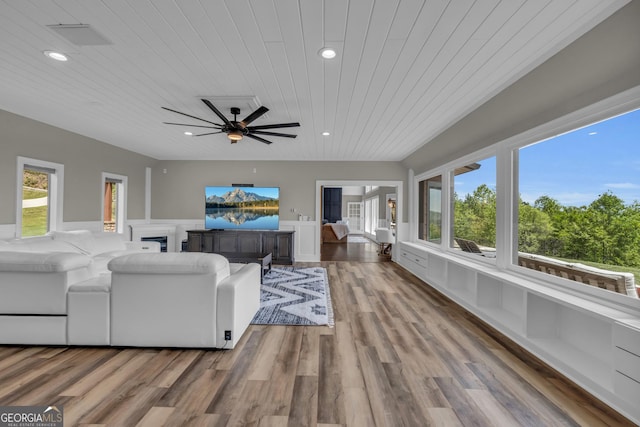 living area featuring wooden ceiling, a ceiling fan, recessed lighting, a fireplace, and wood finished floors