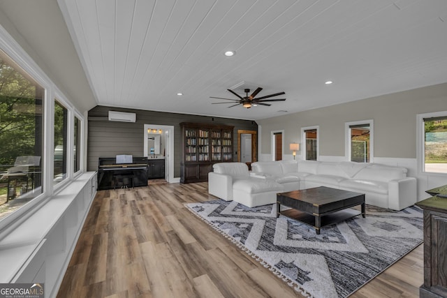 living room with recessed lighting, wooden ceiling, wood finished floors, a ceiling fan, and wooden walls