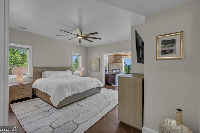 bedroom featuring baseboards, dark wood-style flooring, and ceiling fan