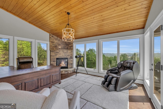 living room with vaulted ceiling, wood ceiling, healthy amount of natural light, a chandelier, and a fireplace