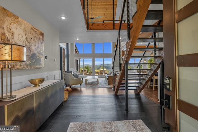 entrance foyer with stairs, dark wood-type flooring, and recessed lighting