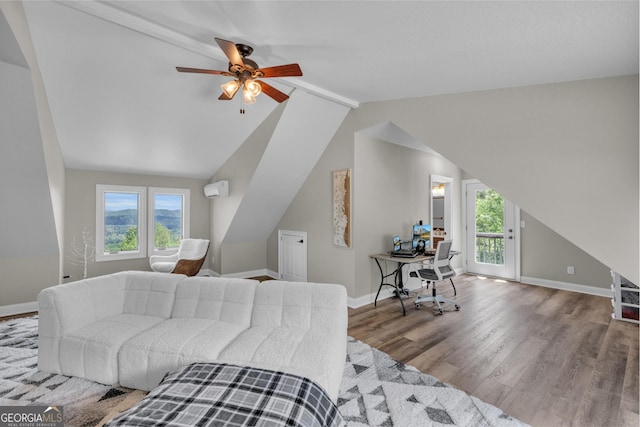 bedroom with wood finished floors, access to outside, lofted ceiling, an office area, and baseboards