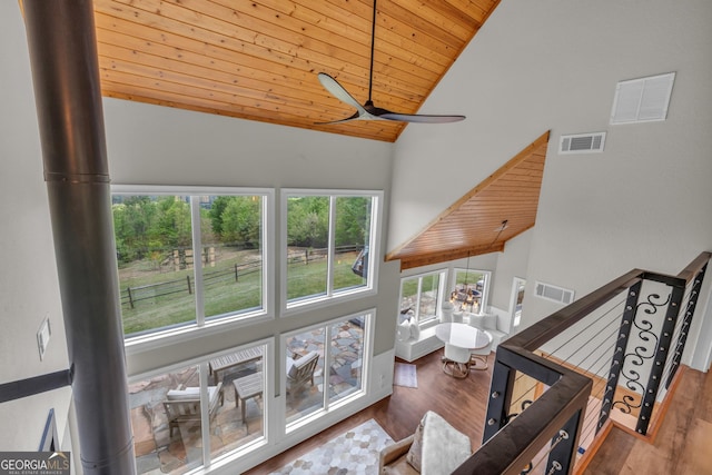 living area featuring wooden ceiling, high vaulted ceiling, wood finished floors, and a ceiling fan