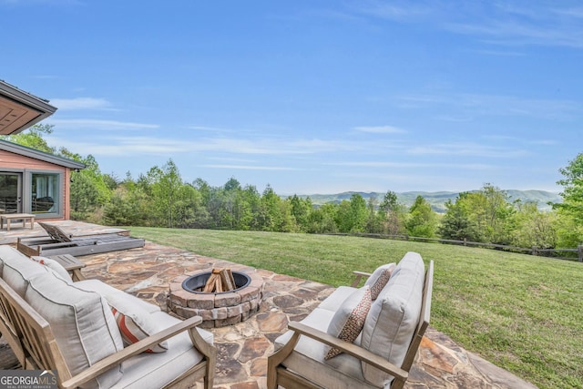 view of patio / terrace featuring an outdoor living space with a fire pit and a mountain view