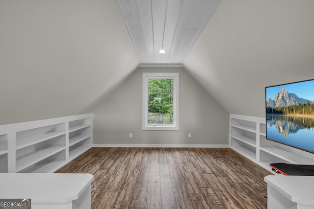 bonus room with built in features, wood finished floors, lofted ceiling, and baseboards