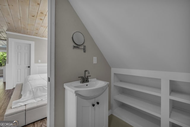 bathroom featuring lofted ceiling, wood ceiling, vanity, and wood finished floors
