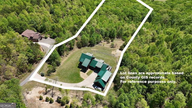view of property location featuring a heavily wooded area and property boundaries highlighted