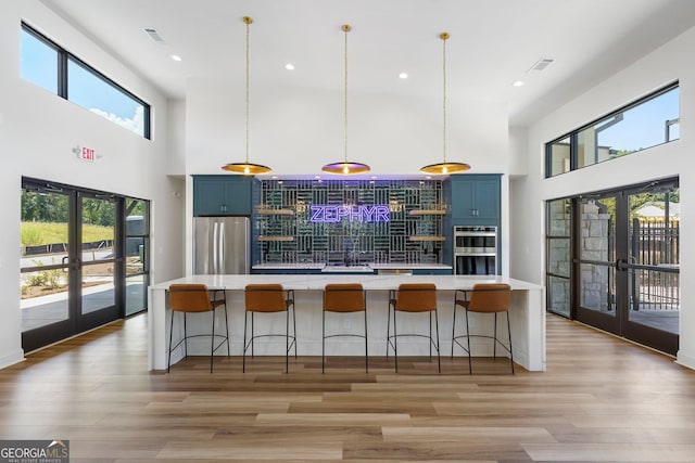 1429 Hazy Way Unit 309, Atlanta, GA 30315 - kitchen with french doors, blue cabinetry, appliances with stainless steel finishes, a towering ceiling, and recessed lighting