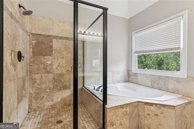 full bath featuring a shower stall and a garden tub