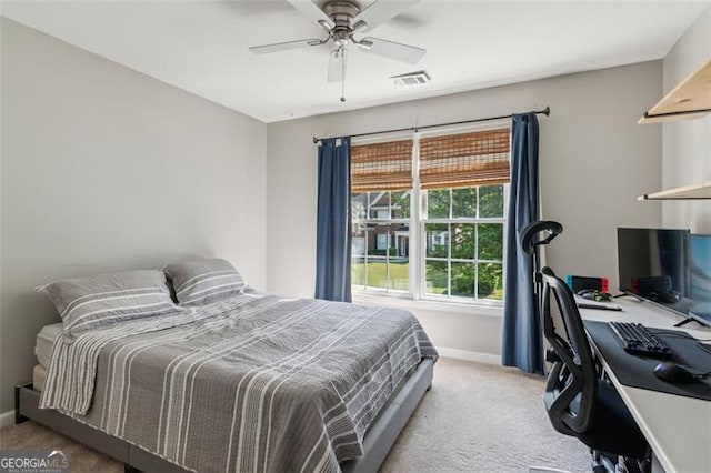 carpeted bedroom featuring an office area, baseboards, and a ceiling fan