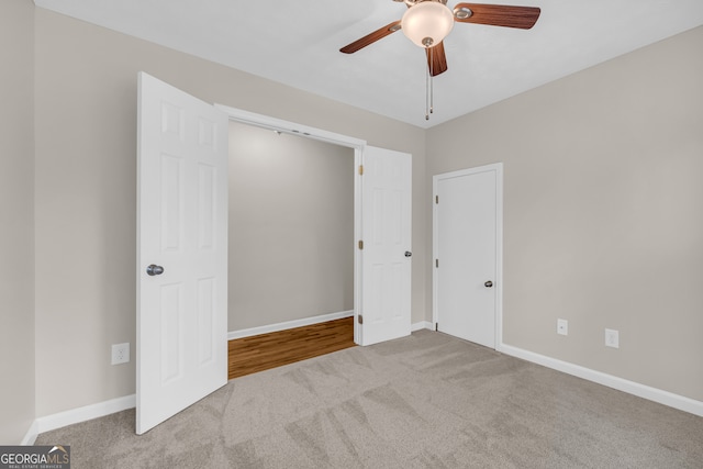 unfurnished bedroom with carpet, baseboards, and a ceiling fan