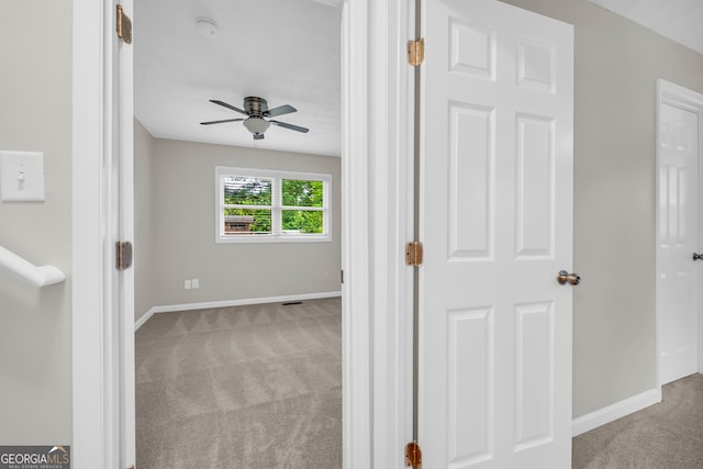 corridor with carpet and baseboards