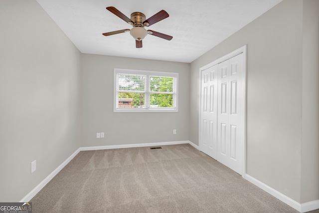 unfurnished bedroom featuring baseboards, a closet, and carpet