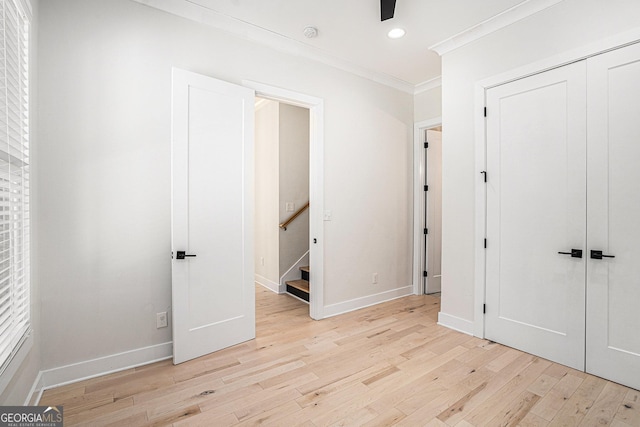4276 Lindsey Way NE, Roswell, GA 30075 - unfurnished bedroom featuring light wood-style floors, crown molding, recessed lighting, a closet, and baseboards