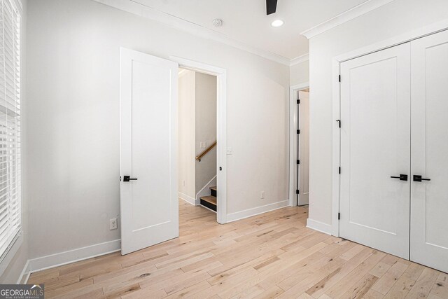 4276 Lindsey Way NE, Roswell, GA 30075 - unfurnished bedroom featuring light wood-style flooring, ornamental molding, a closet, and recessed lighting