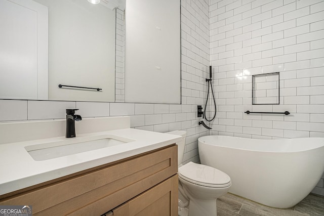 4276 Lindsey Way NE, Roswell, GA 30075 - full bathroom with tile walls, a freestanding bath, toilet, vanity, and backsplash