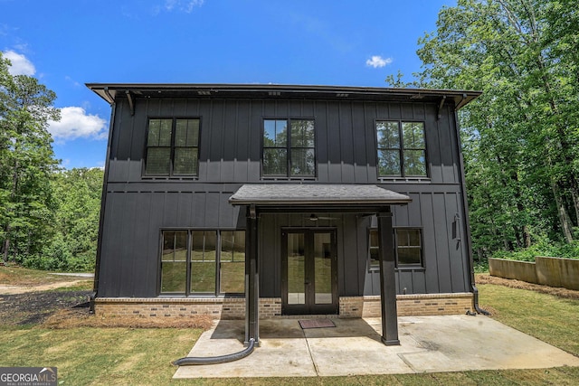4276 Lindsey Way NE, Roswell, GA 30075 - view of front of property with french doors, board and batten siding, brick siding, and a front lawn