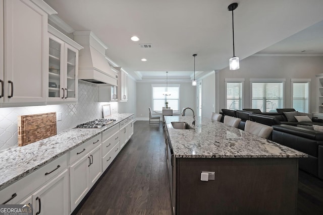 485 Discovery Lake Dr, Fayetteville, GA 30215 - kitchen with a sink, stainless steel gas cooktop, dark wood-style flooring, crown molding, and white cabinetry