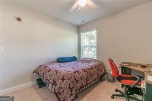 carpeted bedroom with ceiling fan and baseboards