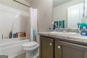 bathroom with toilet, vanity, shower / bathtub combination with curtain, and tile patterned floors