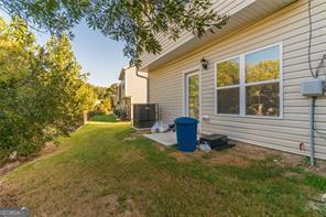 view of property exterior featuring a lawn