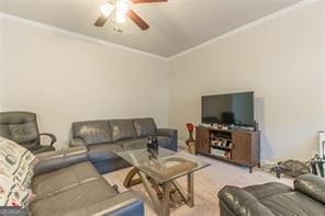 living room with ornamental molding, ceiling fan, and carpet