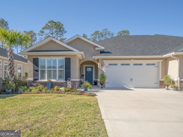 137 Ryan Nicholas Dr, Kingsland, GA 31548 - view of front facade featuring stucco siding, stone siding, a garage, a front yard, and driveway