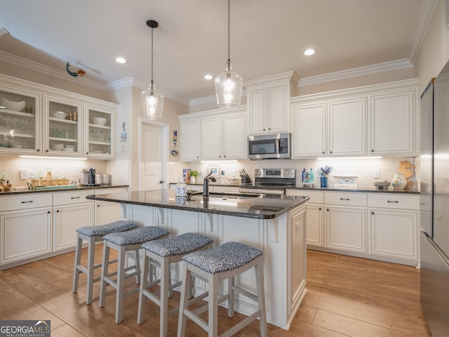 137 Ryan Nicholas Dr, Kingsland, GA 31548 - kitchen with appliances with stainless steel finishes, a sink, ornamental molding, white cabinetry, and recessed lighting