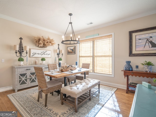 137 Ryan Nicholas Dr, Kingsland, GA 31548 - dining space featuring a chandelier, crown molding, baseboards, and light wood-type flooring