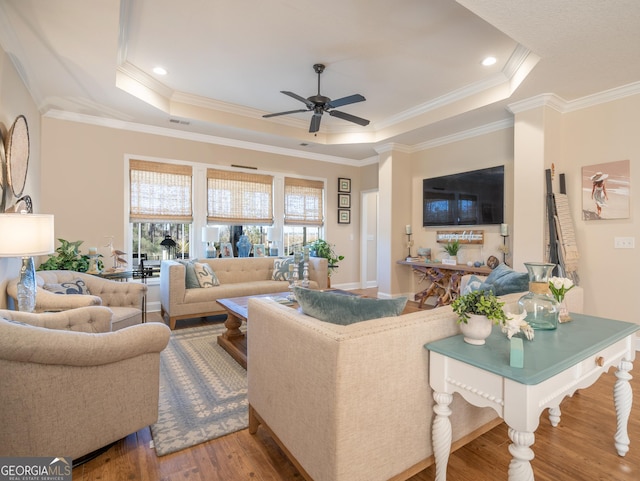 137 Ryan Nicholas Dr, Kingsland, GA 31548 - living room with a raised ceiling, wood finished floors, a ceiling fan, ornamental molding, and recessed lighting