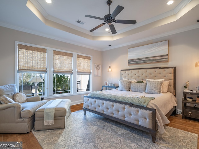 137 Ryan Nicholas Dr, Kingsland, GA 31548 - bedroom featuring a raised ceiling, wood finished floors, ornamental molding, ceiling fan, and baseboards