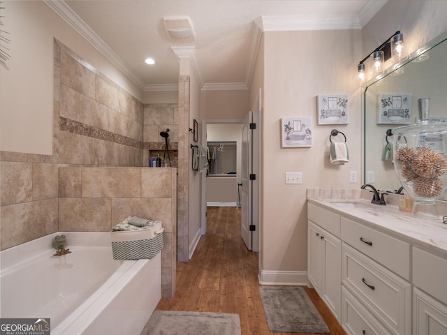 137 Ryan Nicholas Dr, Kingsland, GA 31548 - full bath featuring a bath, wood finished floors, ornamental molding, tiled shower, and vanity