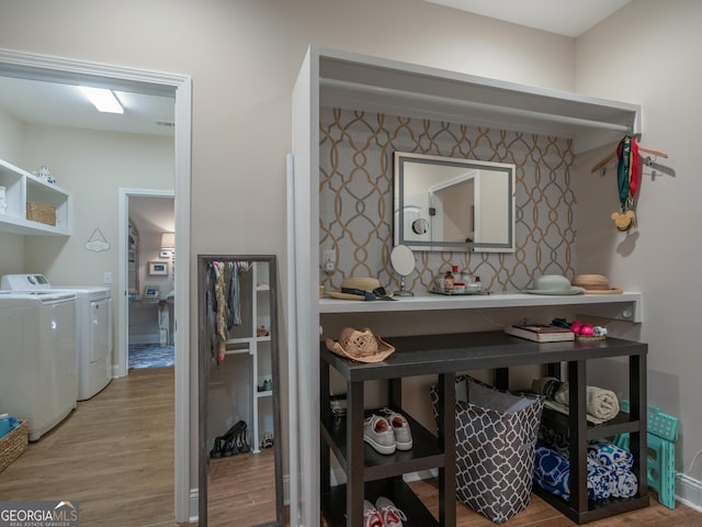 137 Ryan Nicholas Dr, Kingsland, GA 31548 - corridor featuring washing machine and dryer and wood finished floors