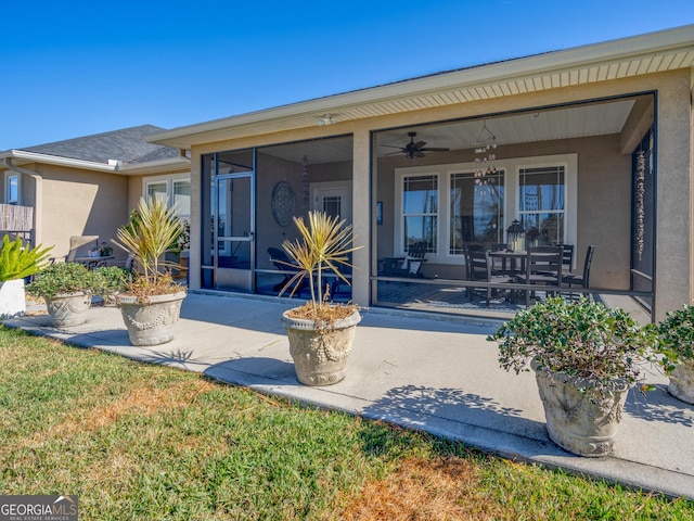 137 Ryan Nicholas Dr, Kingsland, GA 31548 - back of property featuring stucco siding, ceiling fan, and a sunroom