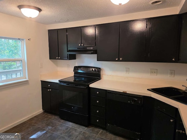 kitchen featuring black appliances, under cabinet range hood, dark cabinetry, light countertops, and a textured ceiling