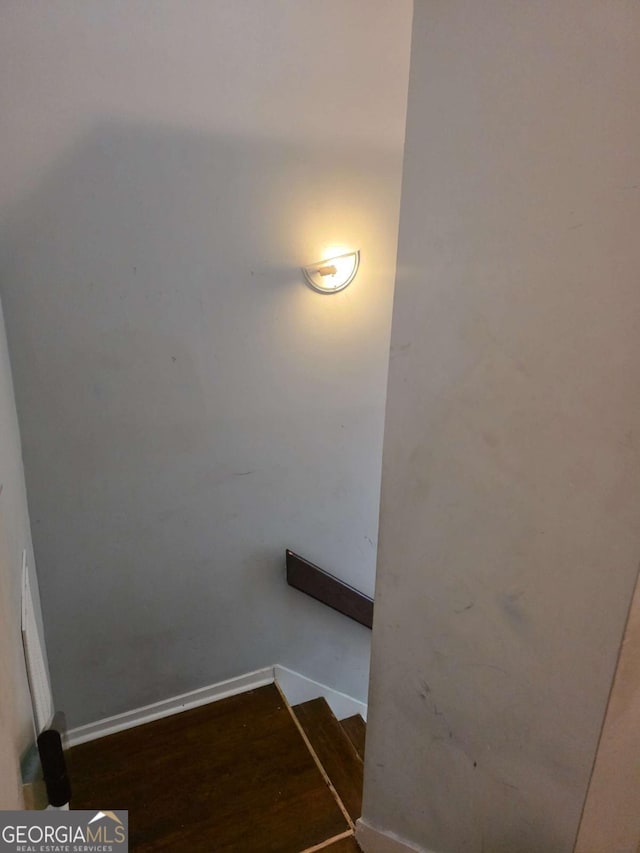 stairs featuring baseboards and wood finished floors