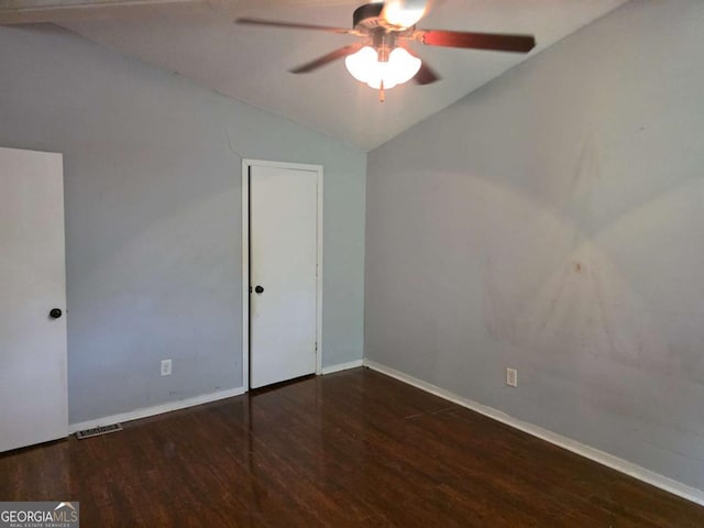 unfurnished bedroom featuring lofted ceiling, wood finished floors, baseboards, and ceiling fan