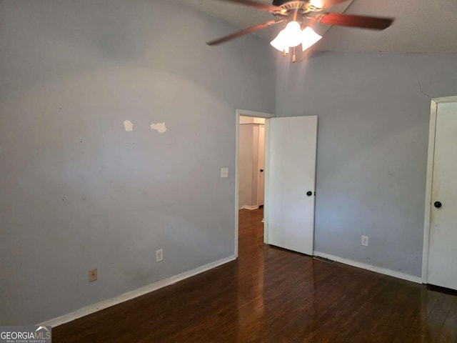 unfurnished bedroom featuring wood finished floors, baseboards, lofted ceiling, and a ceiling fan