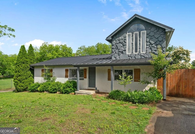 view of front of house featuring a standing seam roof, stucco siding, and metal roof