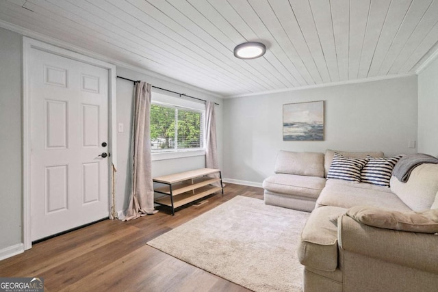 living room featuring crown molding, wooden ceiling, wood finished floors, and baseboards