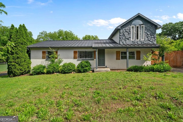 view of front facade with a standing seam roof, metal roof, and stucco siding