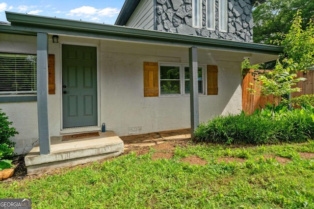 view of exterior entry featuring stucco siding