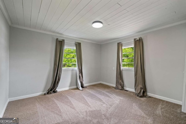 empty room with plenty of natural light, carpet flooring, crown molding, wood ceiling, and baseboards