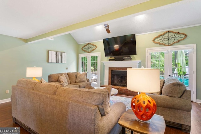 836 Palmetto Tyrone Rd, Sharpsburg, GA 30277 - living area with french doors, dark wood-style floors, vaulted ceiling, baseboards, and a brick fireplace