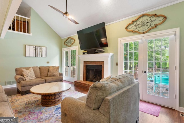 836 Palmetto Tyrone Rd, Sharpsburg, GA 30277 - living area with ceiling fan, wood finished floors, french doors, a brick fireplace, and high vaulted ceiling