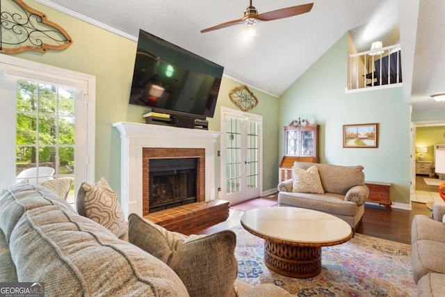 836 Palmetto Tyrone Rd, Sharpsburg, GA 30277 - living room with ceiling fan, wood finished floors, high vaulted ceiling, a brick fireplace, and baseboards